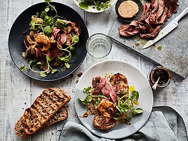 Open sourdough sandwich with steak, caramelised onions, watercress and umami butter