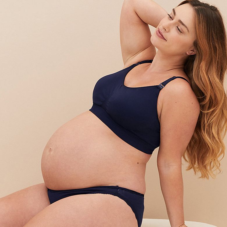 Woman wearing navy maternity and nursing bra and navy knickers. Shop now 