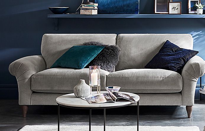 Comfortable grey sofa with cushions