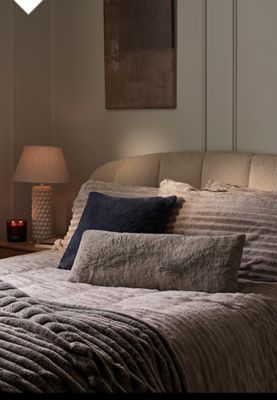 Double bed with padded headboard and ribbed fleece bedding. Shop headboards