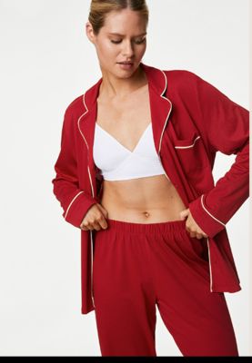 Woman wearing red  pyjamas. Shop now