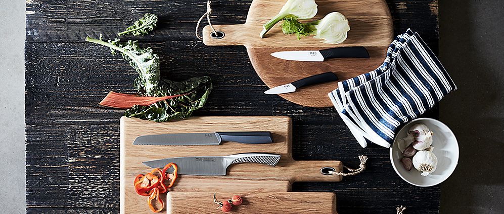 Kitchen knives on wooden chopping boards