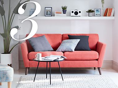 A bright red sofa with cushions