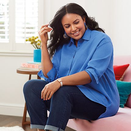 Model wearing a blue linen shirt and indigo straight-leg jeans from the Curve collection