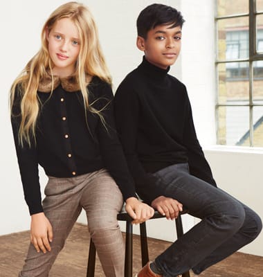 A boy and a girl wearing wool jumpers