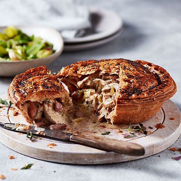 Chicken, leek and smoked bacon pie with a bowl of spring greens