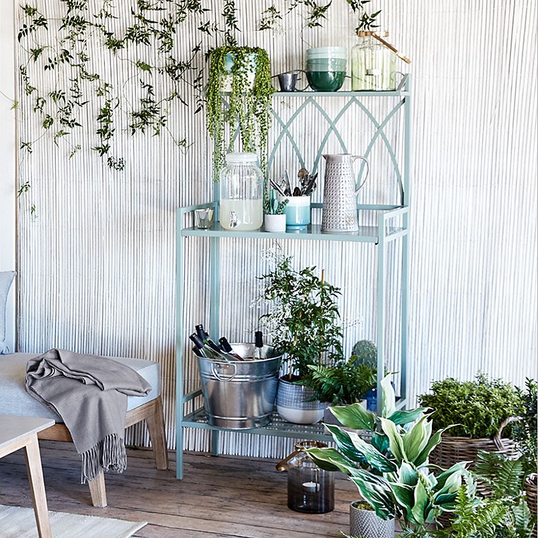Rosedale metal garden shelving with drinks and potted plants