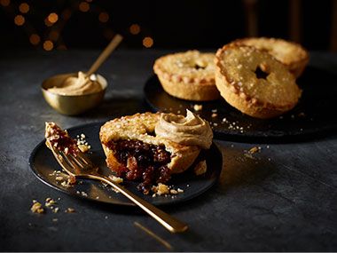A plate of mince pies and a scoop of cream
