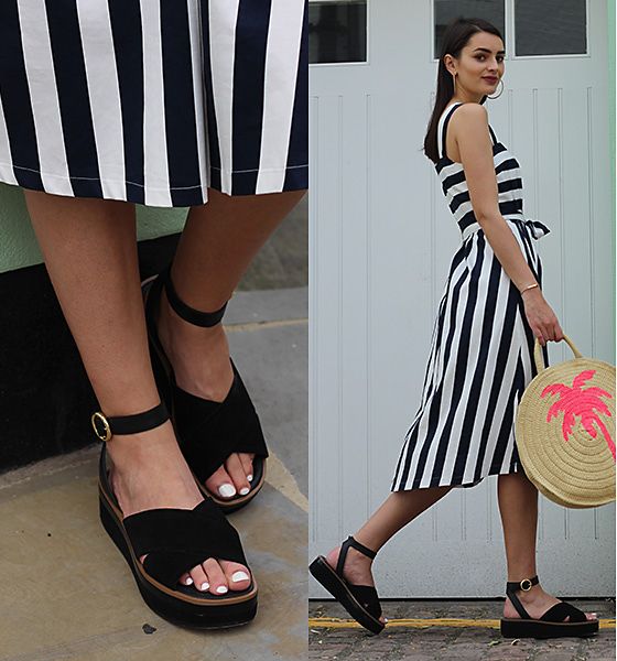 Patricia Batatas from Peexo wearing a black and white striped summer dress, a palm-print straw bag and black suede cross-strap sandals
