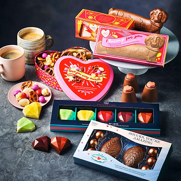 M&S collection of chocolates on table with cups of tea