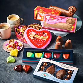 M&S collection of chocolates on table with cups of tea