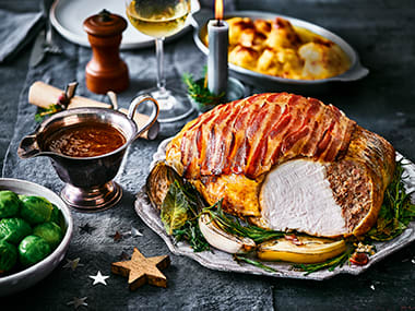 Carved turkey with cranberry sauce, Brussels sprouts and potatoes