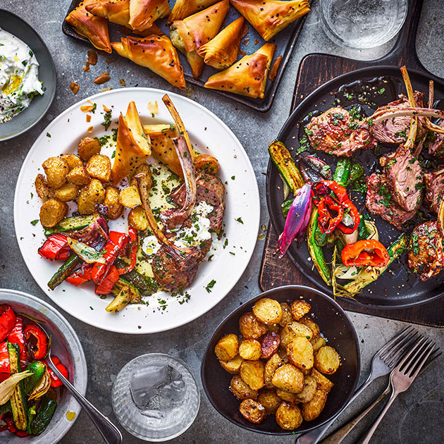 Mezze of Cypriot lamb chops, crispy new potatoes, roasted red peppers and baby courgettes, tzatziki, and halloumi and spinach filo parcels