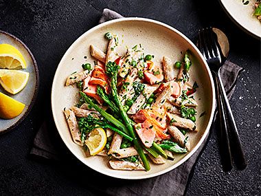 A pasta dish with salmon and asparagus