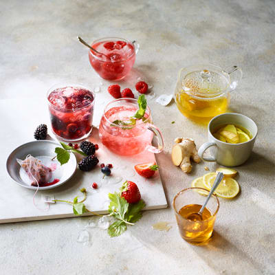 A selection of fruit and herbal teas in iced jugs or steaming cups