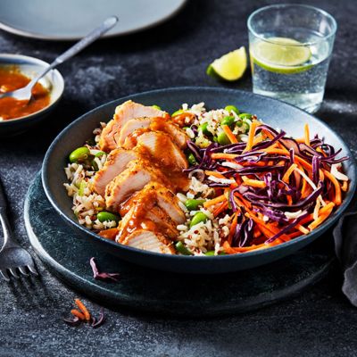 Chicken katsu with brown rice and crunchy slaw served in a bowl