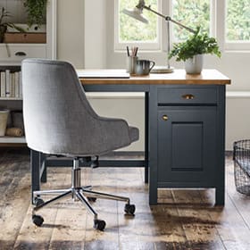 Dark grey and wood desk with light grey office chair