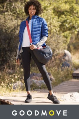 Woman wearing leggings, a top and padded jacket