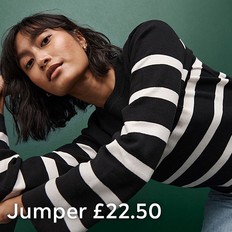 Woman wearing a striped jumper. Shop women’s knitwear
