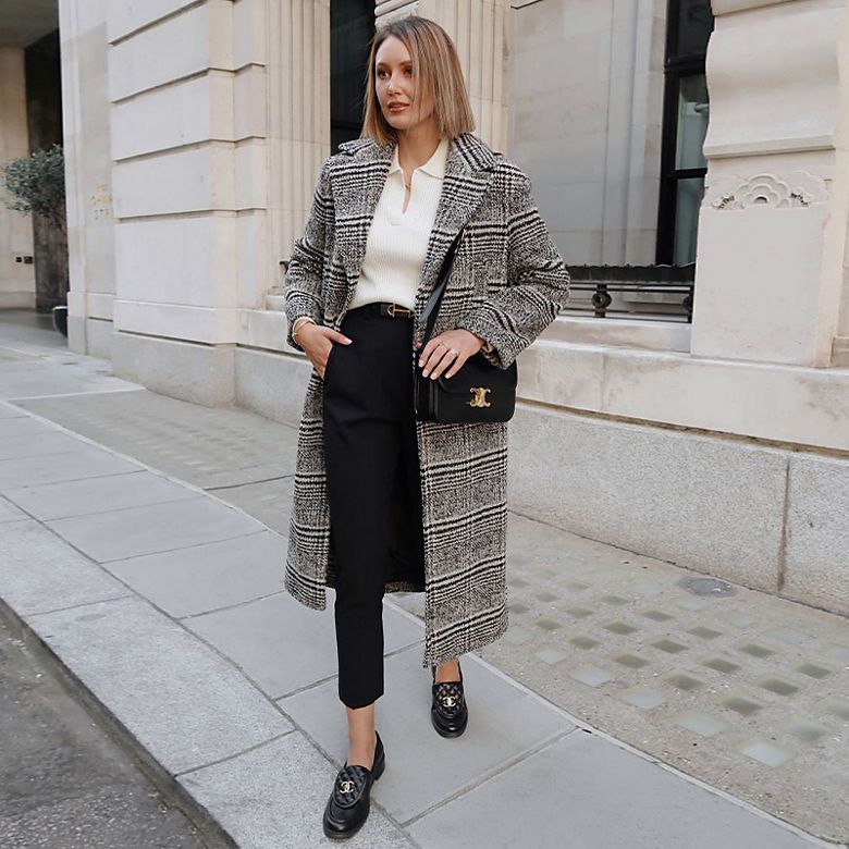 Justine wearing longline grey checked coat with black trousers