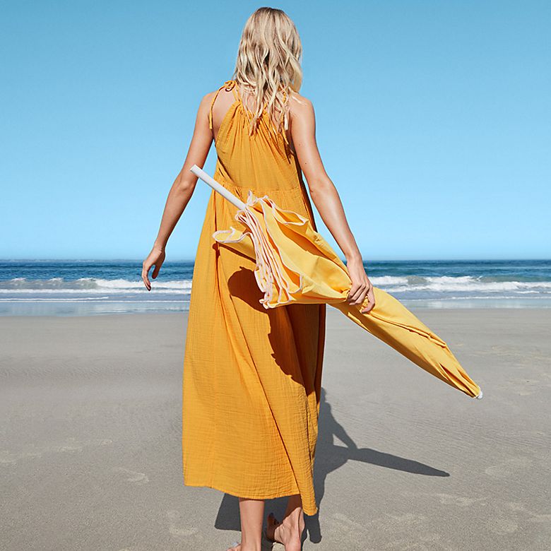 Woman wearing a summer beach dress. Shop all dresses.