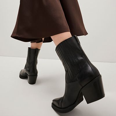 Two pairs of biker boots in black and grey. Shop boots