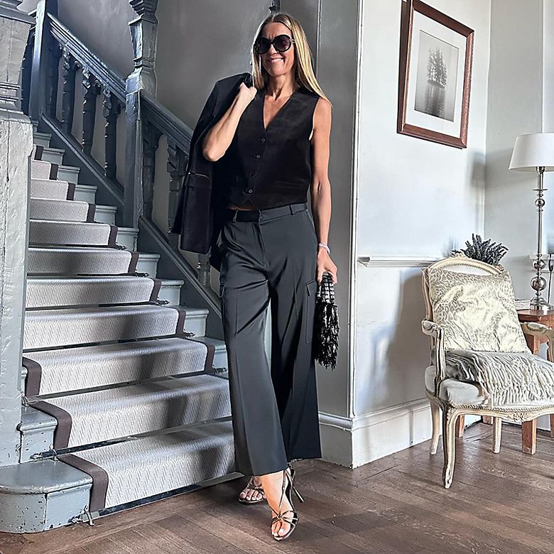 Instagram star Hayley Karseras (@ladyofthemanor77) wears black velvet waist coat, dark grey cargo trousers and strappy heels. Shop women’s waistcoats