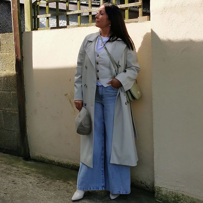 Instagram star @marksandspencerireland_lisa wears grey double-breasted waist coat and grey pleated wide-leg trousers. Shop women’s waistcoats