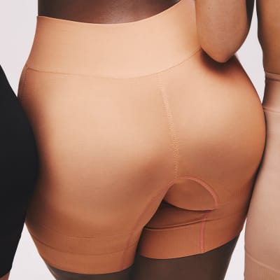 Woman wearing bum-boosting shapewear. Shop now