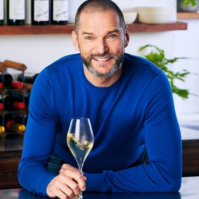 Fred Sirieix with a glass of white wine