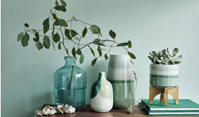 Green vases on a side table
