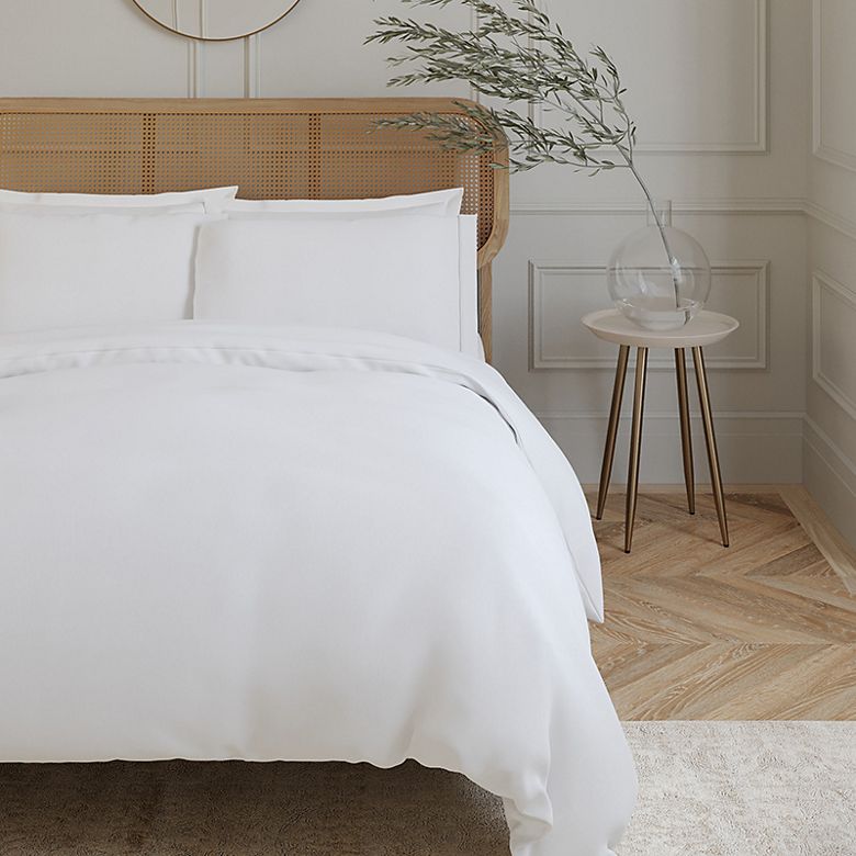 Bedroom showing bed with lightweight summer duvet and pillows. Shop the duvet