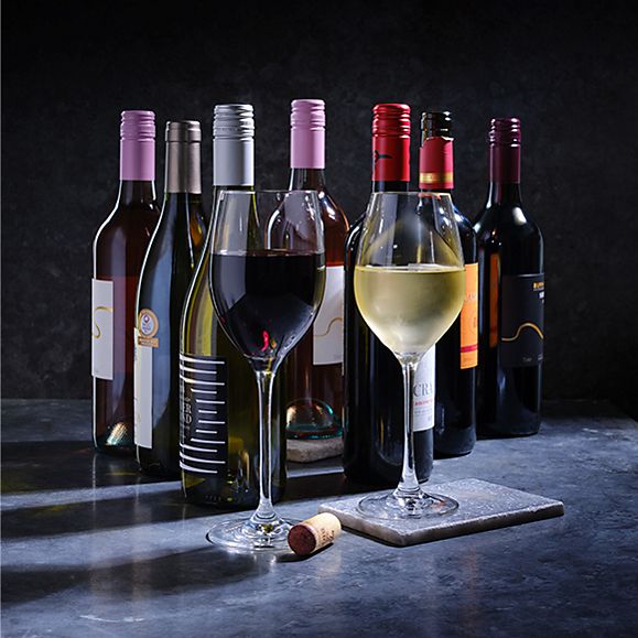 Wine bottles and glasses of red and white wine