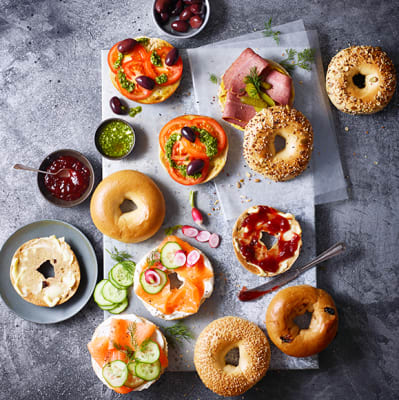 A spread of bagels with different toppings