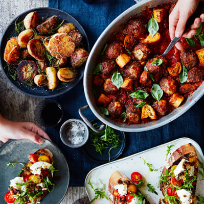 A tray of meatballs, roast potatoes and bruschettas