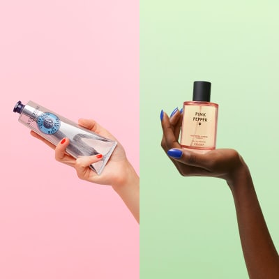 Hand holding L’Occitane shea butter hand cream; hand holding Discover pink pepper eau de toilette