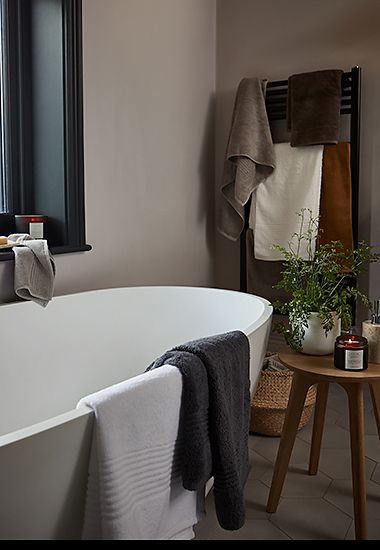 Bathroom with towels, candles and plants