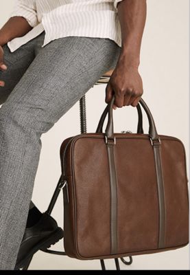 Man holding brown leather laptop case