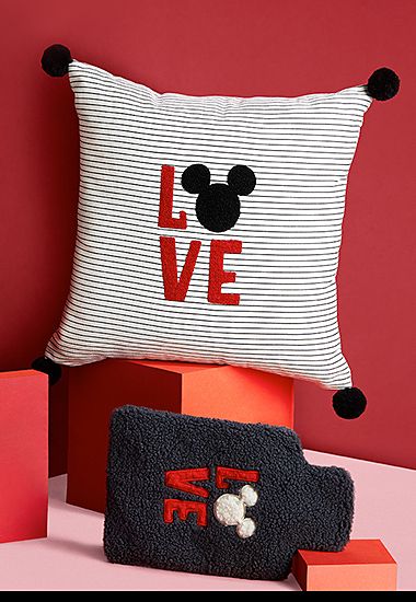 Mickey Mouse black and white striped cushion and fluffy black hot-water bottle