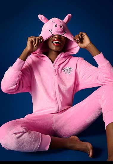 Woman wearing Percy Pig onesie. Shop now