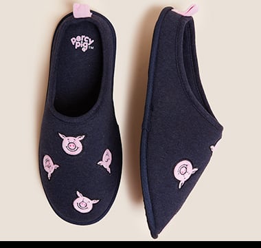 Navy mule slippers with pink Percy Pig print. Shop now