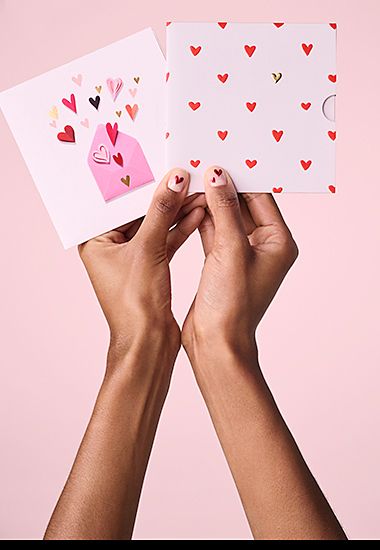 Woman’s hands holding a selection of gift cards. Shop now 