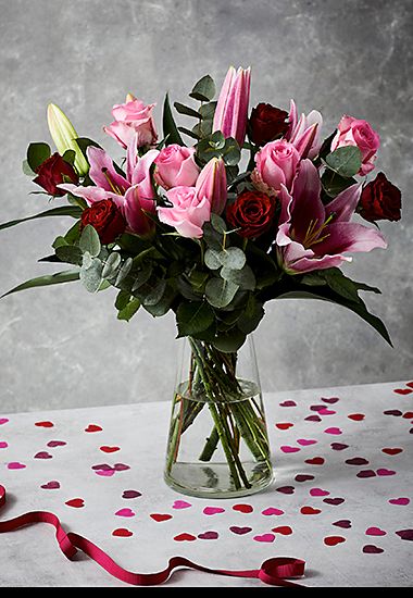 Bouquet of red and pink roses and lilies. Shop now 