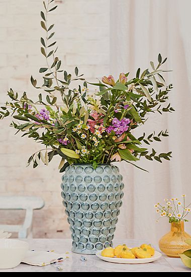 Bouquet of spring flowers in a ceramic vase. Shop all flowers. 