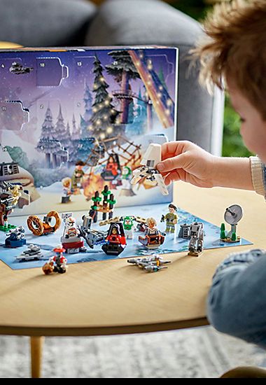 Child playing with Lego Star Wars advent calendar. Shop noww