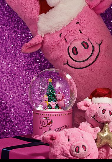 A collection of Percy Pig gifts including a Christmas stocking and snow globe. Shop Percy Pig gifts 