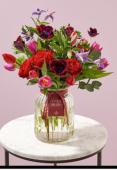 Valentine’s tulip and anemone bouquet in glass vase. Shop now