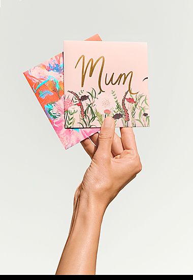 Hand holding Mother’s Day gift cards. Shop gift cards.