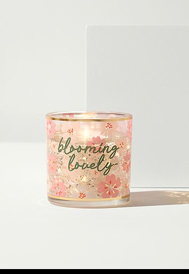 Light-up candle with “blooming lovely” slogan. Shop now