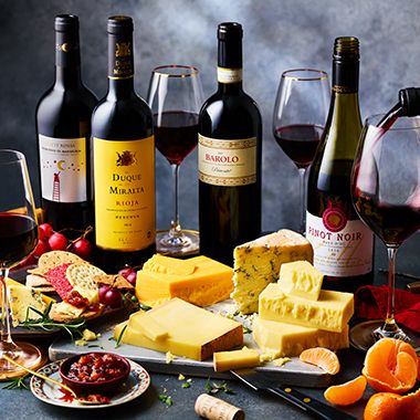 Bottles of red wine and a cheeseboard